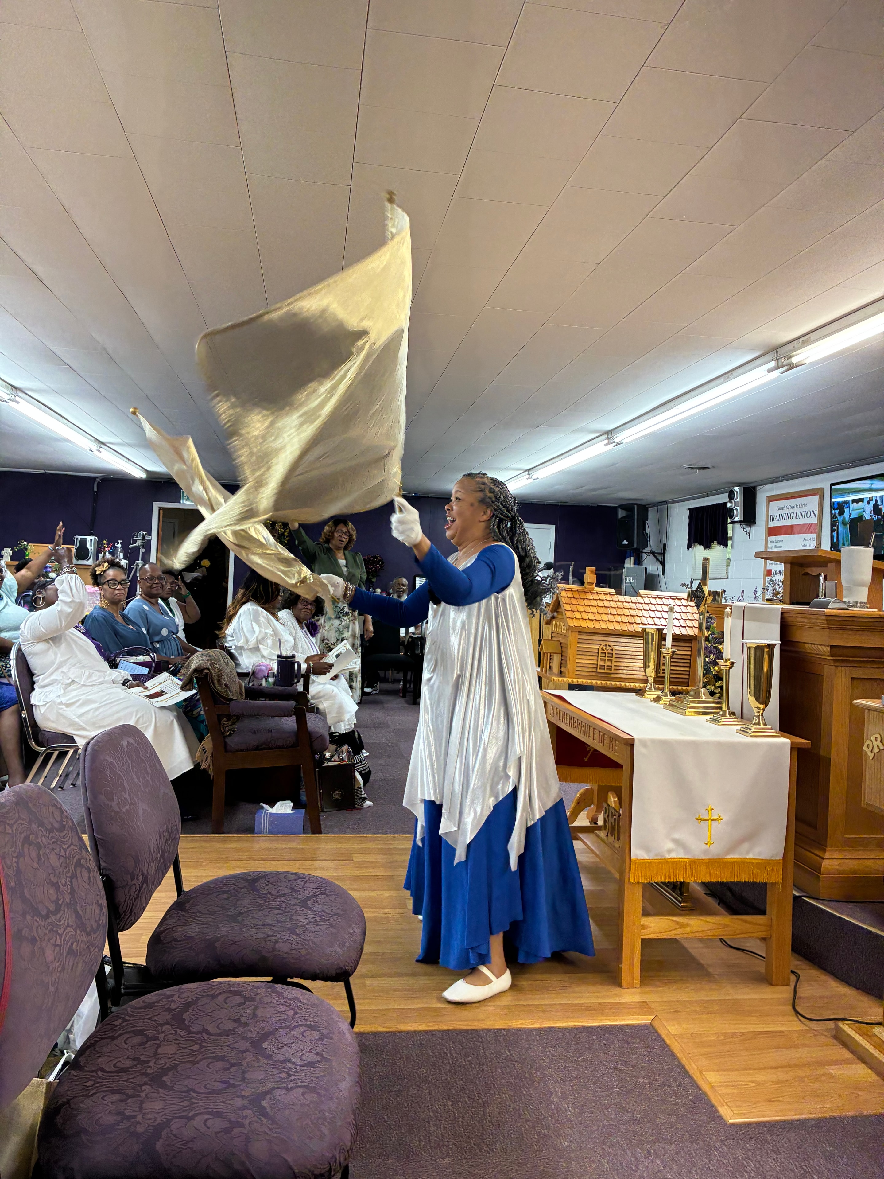 Praise dancer waving flags in worship at House of Another Chance COGIC