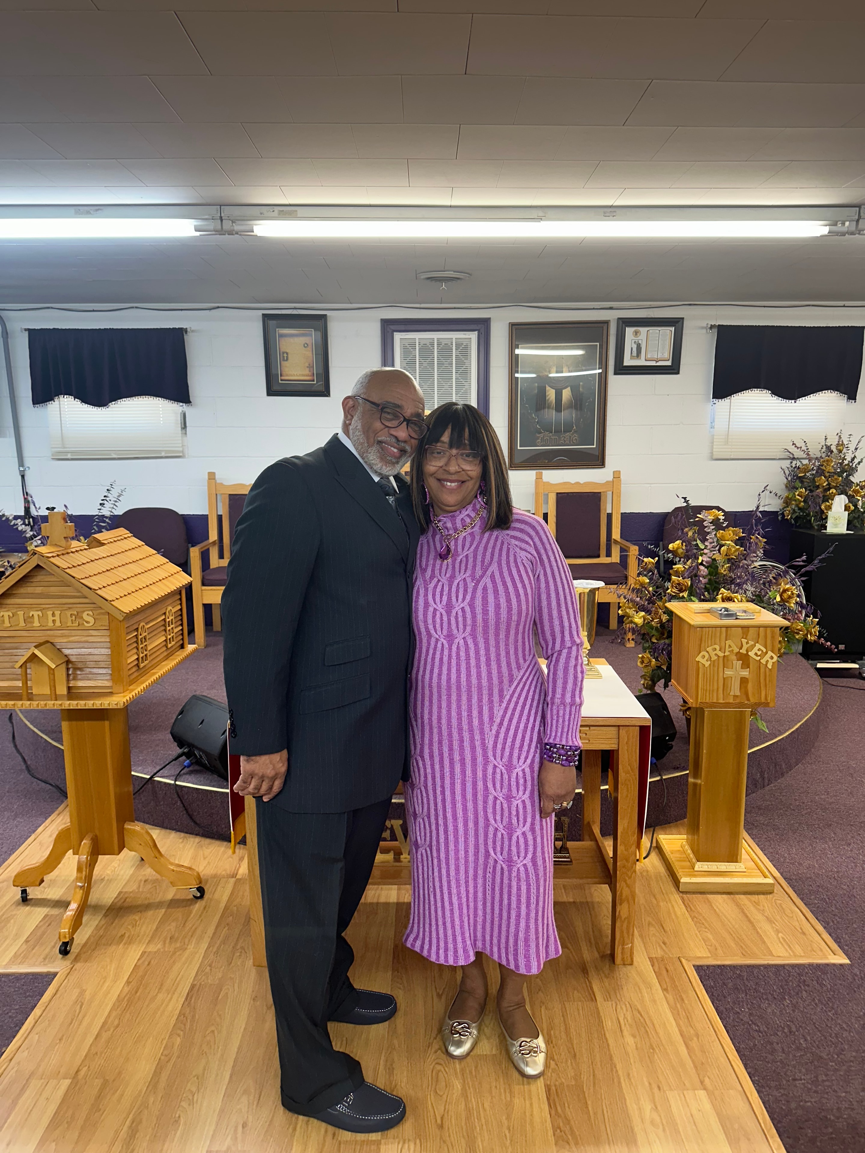 Pastor and First Lady smiling together at the altar